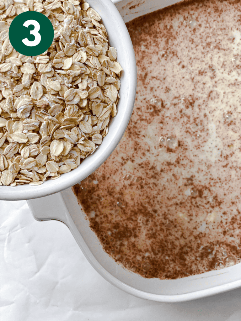 process shot showing the addition of oats to baking dish