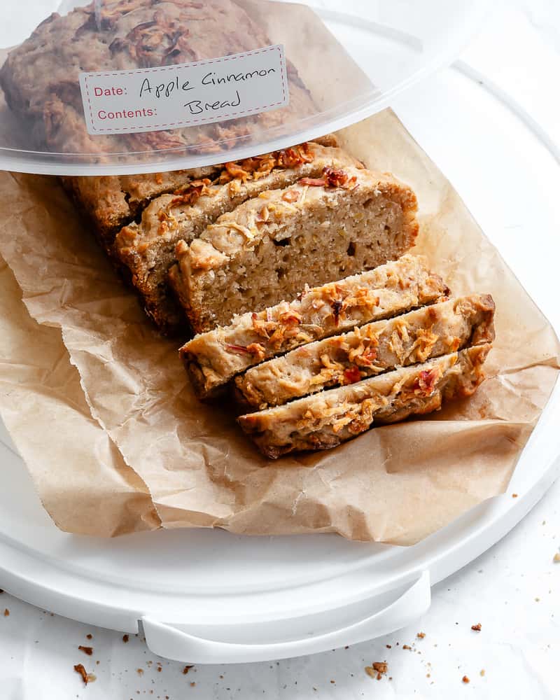 sliced apple cinnamon bread in a container with a label that says, "apple cinnamon bread".