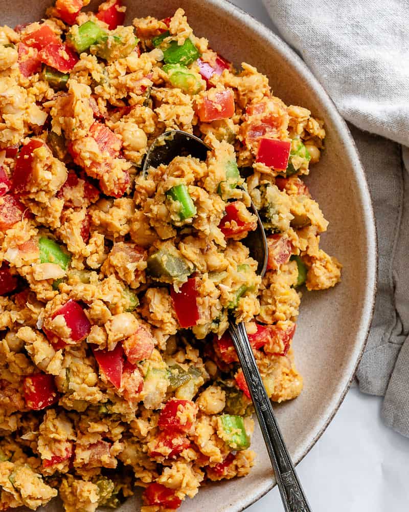 close up on vegan garbanzo bean salad in a large white bowl.