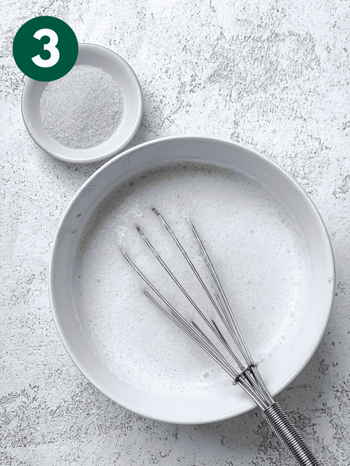 whisking vegan buttermilk in a white bowl.