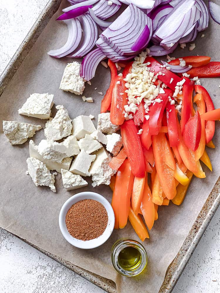 process shot showing veggies and tofu on bakind dish