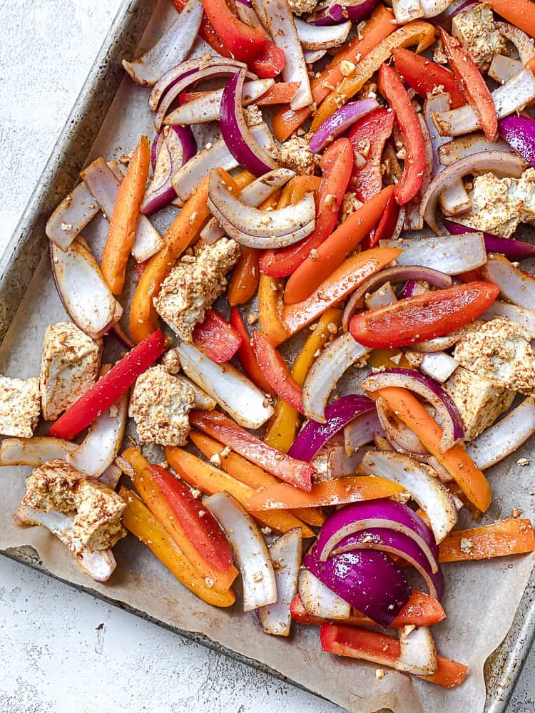 process shot showing post baked tofu and veggies on baking tray