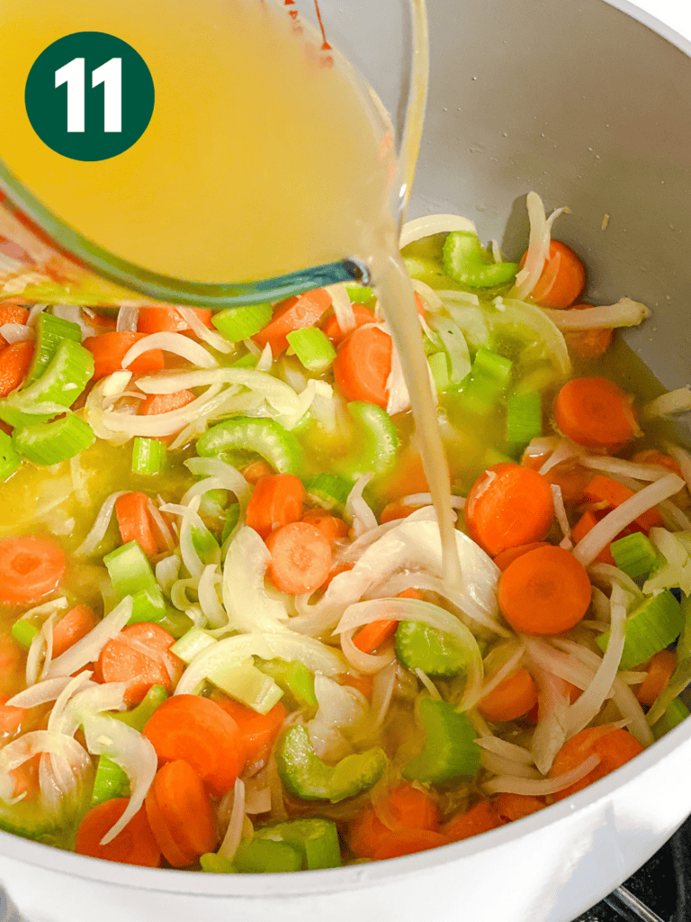 process shot showing adding broth to veggies