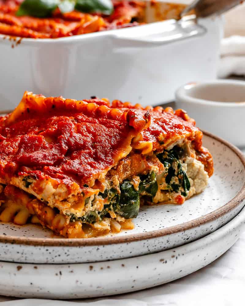 a piece of vegan lasagna on a white plate.