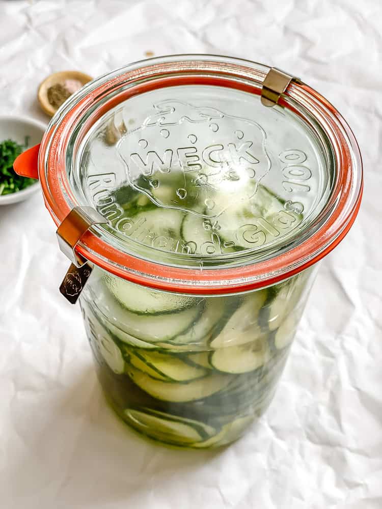 cucumber dill salad in a sealed glass jar.