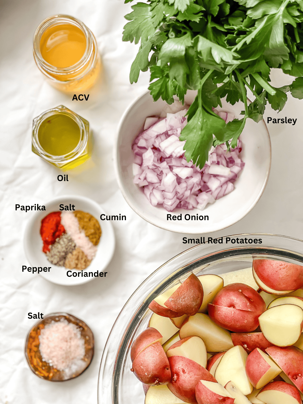 ingredients for french potato salad in individual bowls with labels.