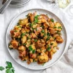 french potato salad on a white plate.