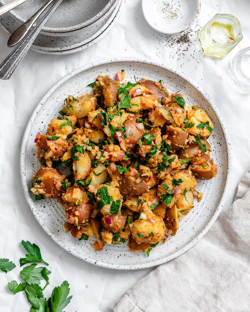 french potato salad on a white plate.