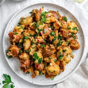 french potato salad on a white plate.