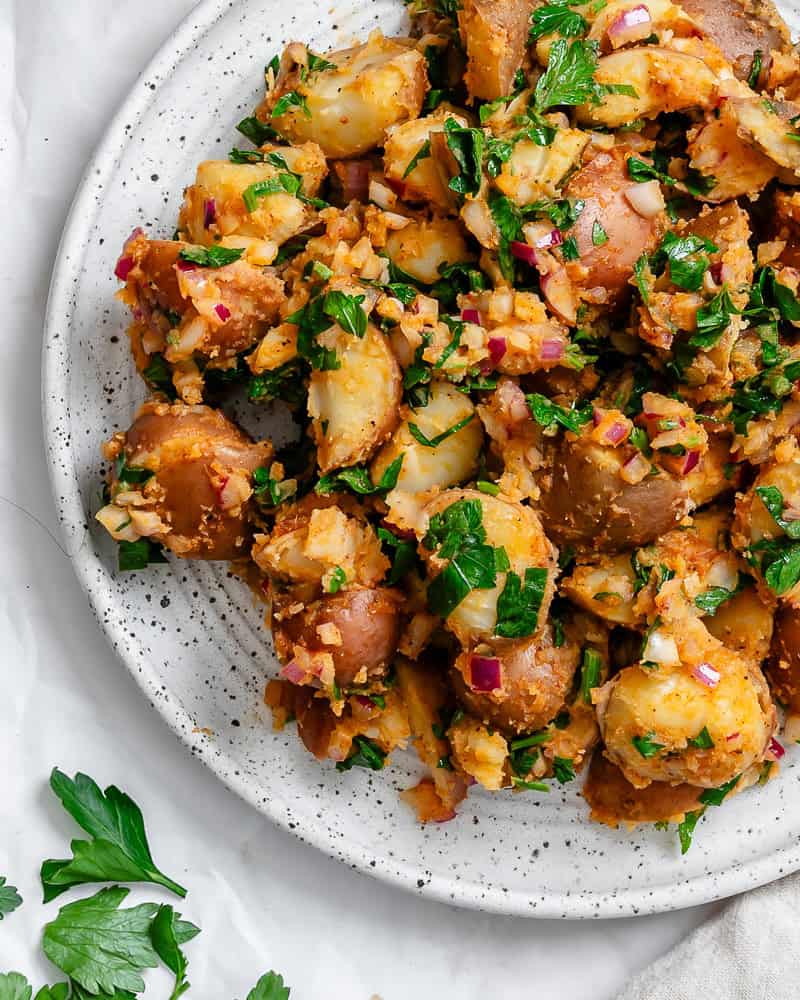 french potato salad on a white plate.