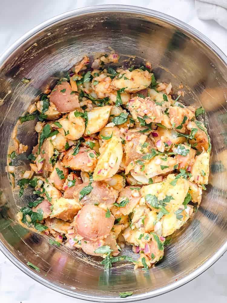 french potato salad in a metal bowl.