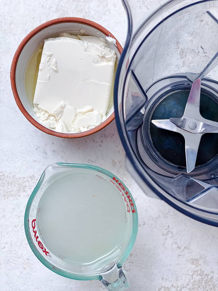 silken tofu and pasta cooking water in separate bowls next to a blender.