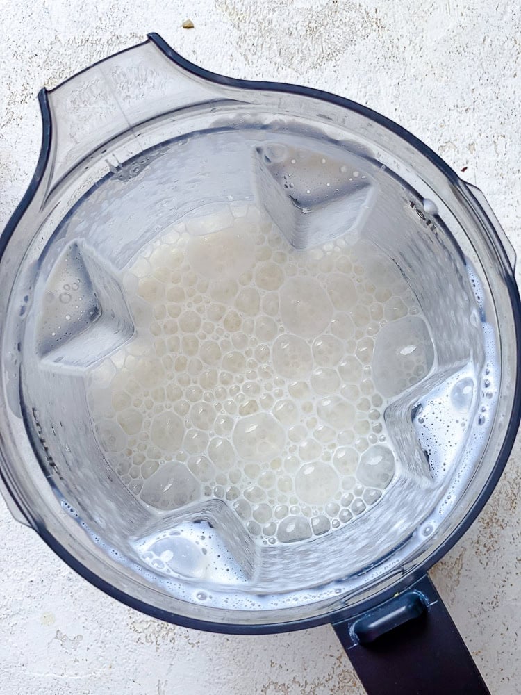 a foamy white sauce in a blender.