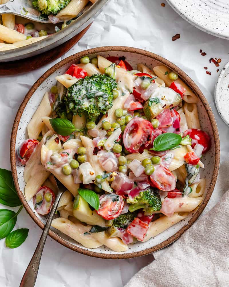 vegan pasta primavera in a white bowl.