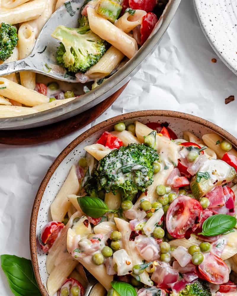 vegan pasta primavera in a white bowl.