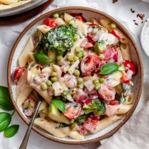 vegan pasta primavera in a white bowl.