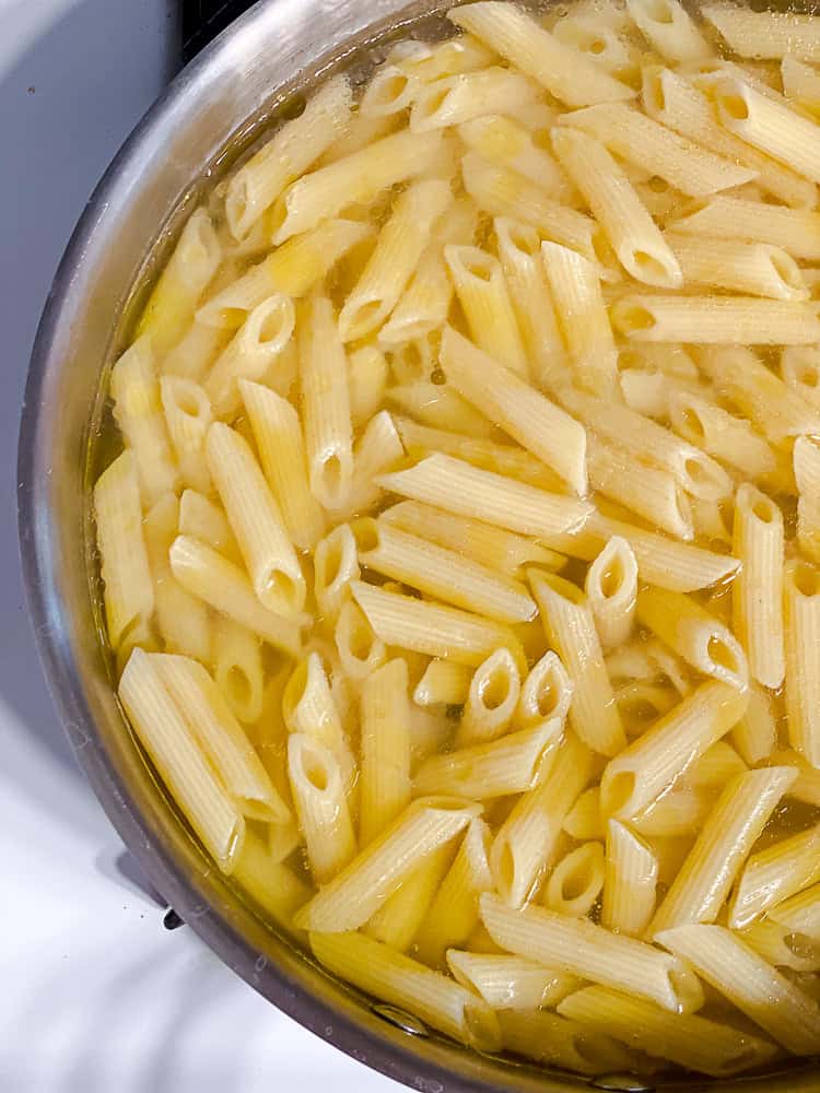 cooking pasta in a pot of boiling water.