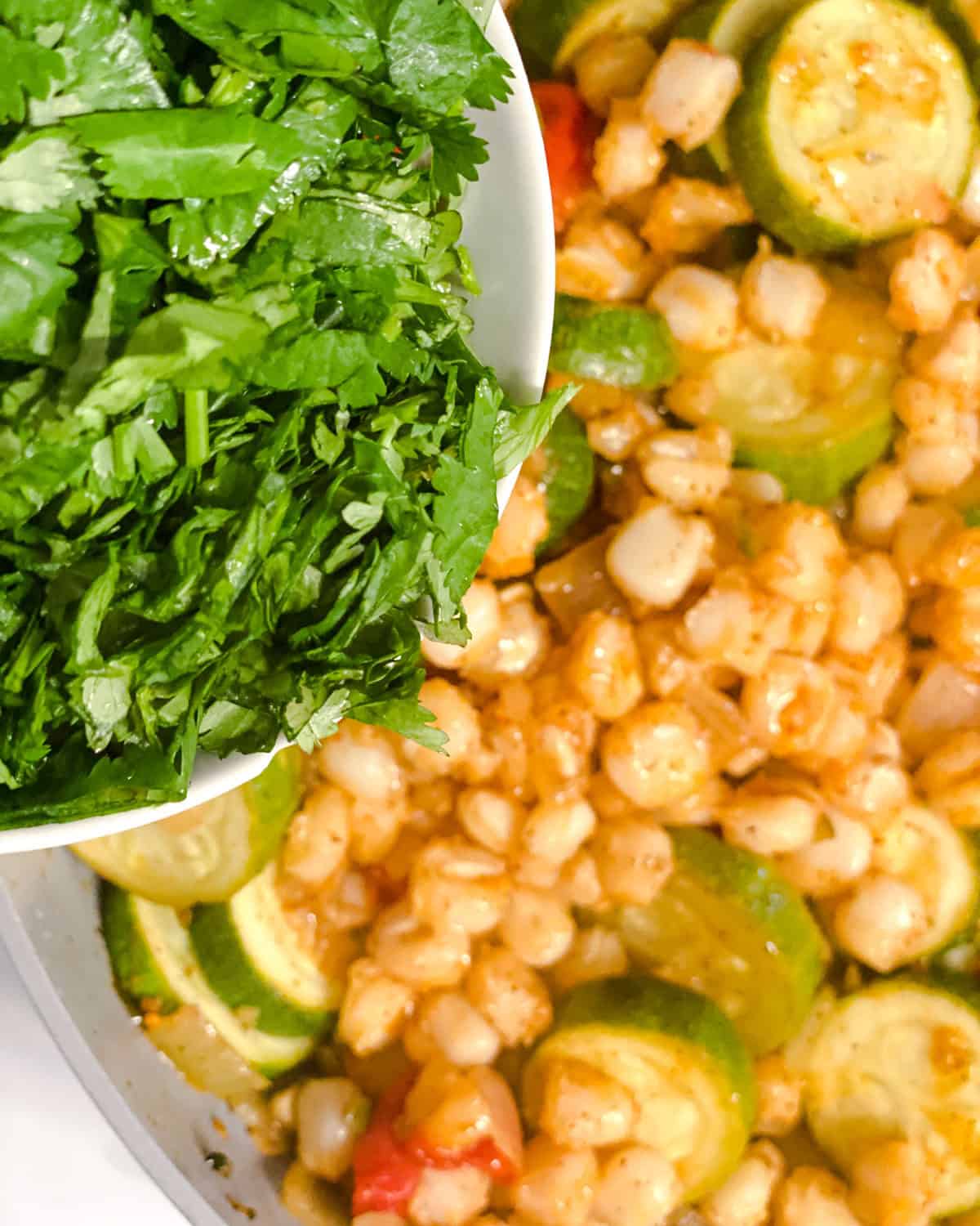 process shot showing veggies being added to dish