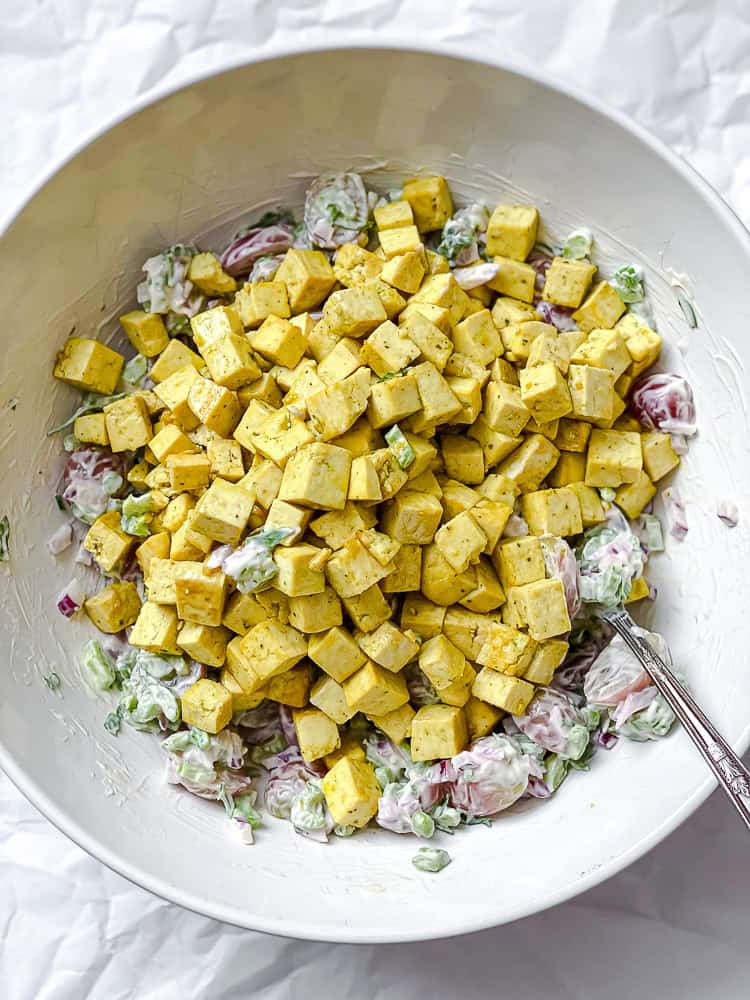 process shot of mixing vegan chicken salad ingredients together