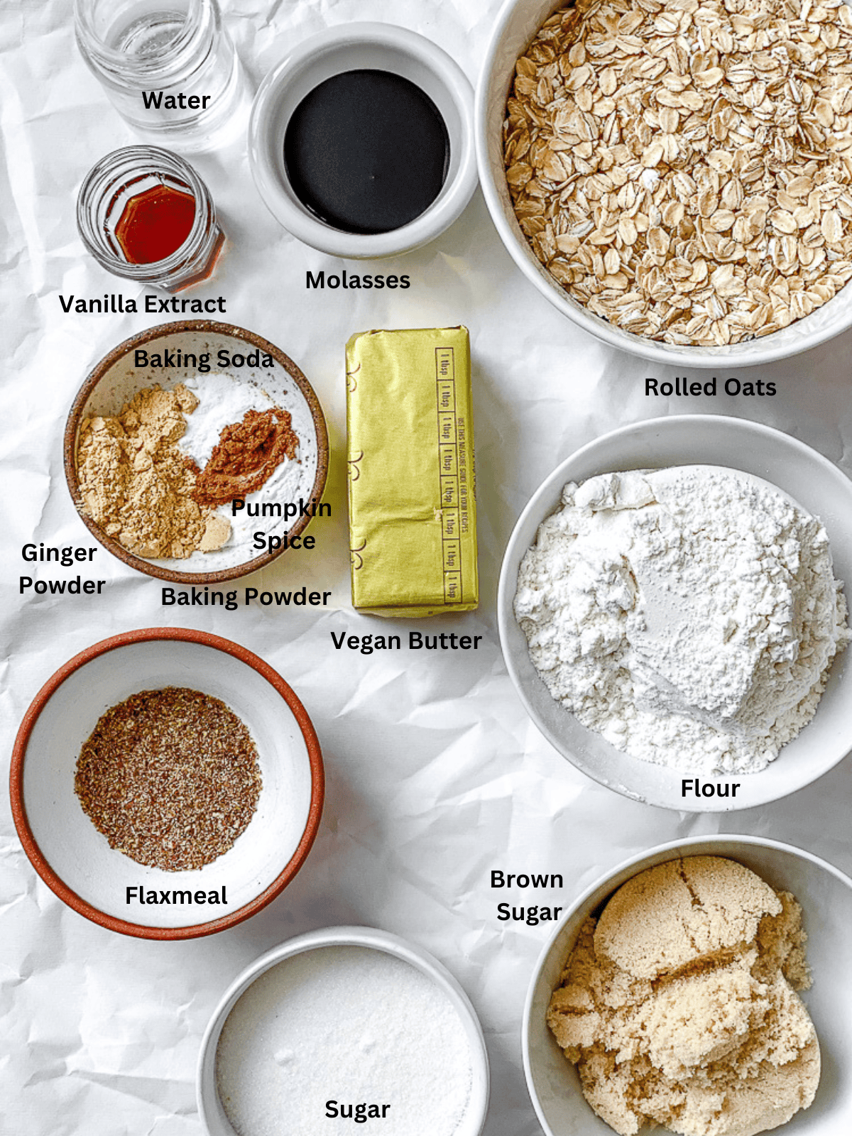 ingredients for Gingerbread Oatmeal Cookies on a white surface