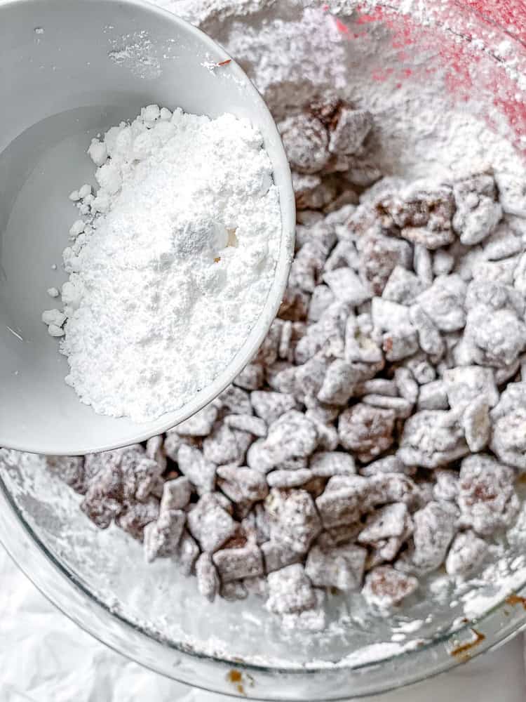 process shot of adding powdered sugar to bowl