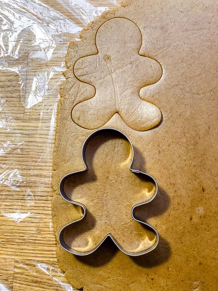 process shot showing cut out for gingerbread men on dough